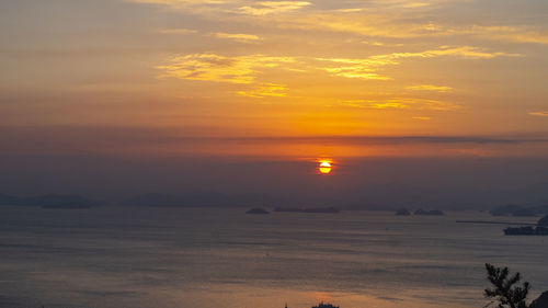 Scenic view of sea against romantic sky at sunset