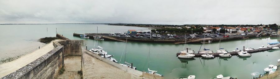 Boats moored in sea against sky