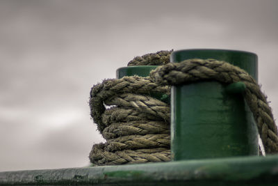 Close-up of rope tied up on wooden post