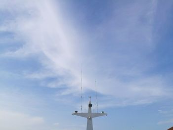 Low angle view of communications tower against blue sky