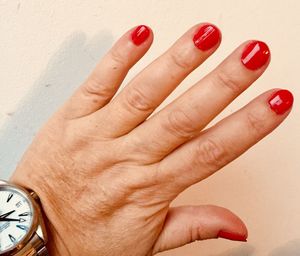 Close-up of woman hand with red finger