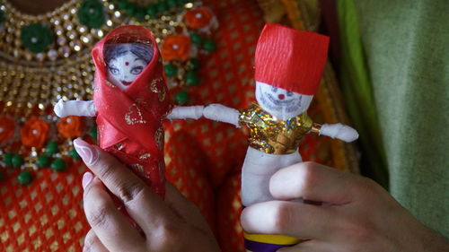 Midsection of person holding christmas decoration