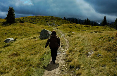 Rear view of woman walking on trail