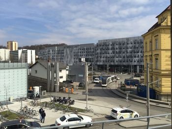 High angle view of cars on city against sky