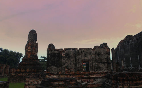 Old ruins temple against sky during sunset