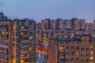 Illuminated cityscape against sky