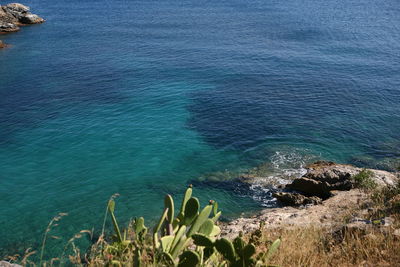 High angle view of rocks by sea