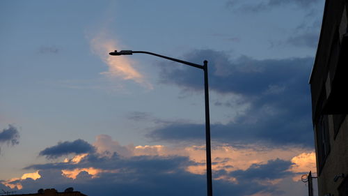 Low angle view of street lights against sky during sunset