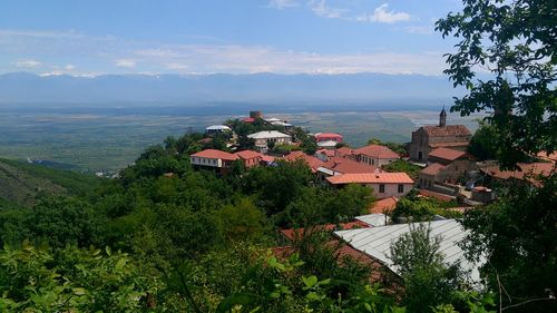 High angle view of houses in town against sky