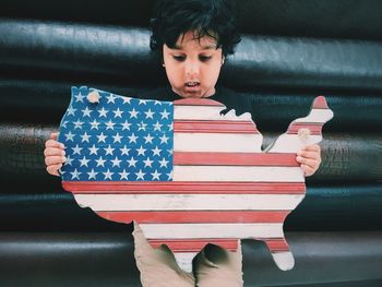 Boy holding american flag map