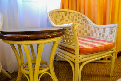 Close-up of chair by table at home