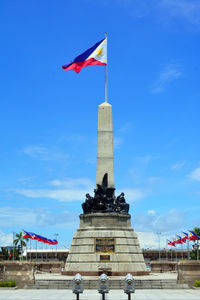 Low angle view of statue against cloudy sky