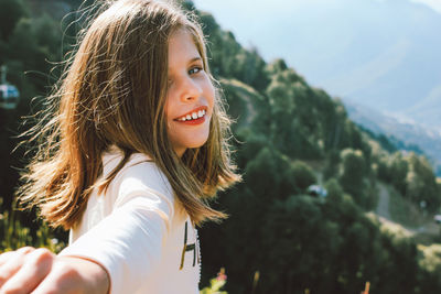 Portrait of smiling girl against sky