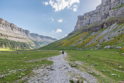 Solitary hiker in the massive mountain valley