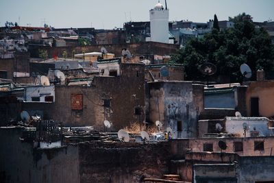 Old buildings in city against sky