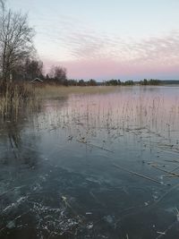 Scenic view of lake against sky during sunset