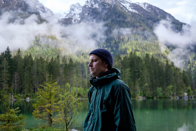 Young man looking away in forest