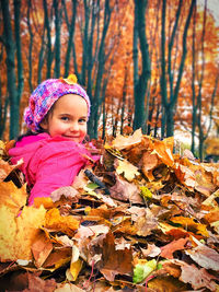Girl in autumn leaves during winter