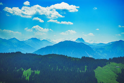 Scenic view of mountains against blue sky