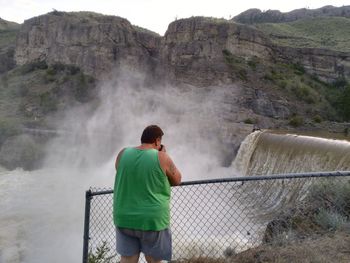 Rear view of man looking at mountains