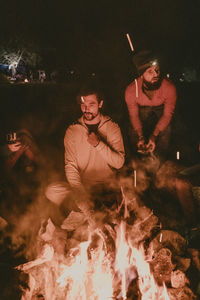 Young man with fire crackers at night