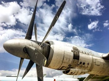 Low angle view of fighter plane against cloudy sky