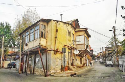 View of street amidst buildings against sky