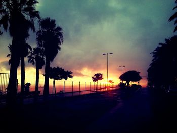 Silhouette palm trees against sky during sunset