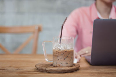 Midsection of man using laptop on table