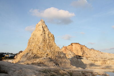 Rock formations on landscape against sky