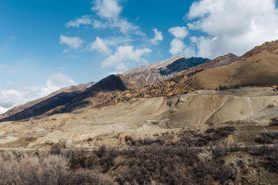 Scenic view of mountains against cloudy sky