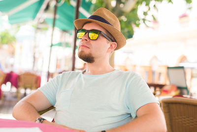 Portrait of young man wearing hat in restaurant