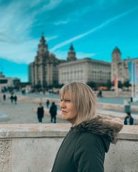 Portrait of woman in front of historic building