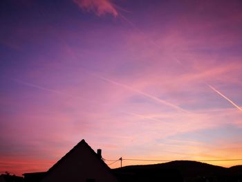 Low angle view of silhouette building against sky during sunset