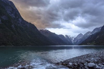 Scenic view of lake and mountains against sky