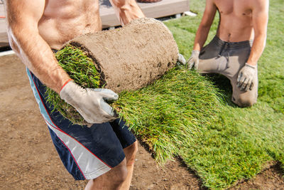 Low section of man working on field