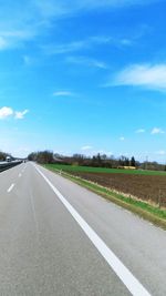 Empty road along countryside landscape