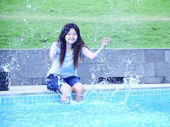 Portrait of young woman in water