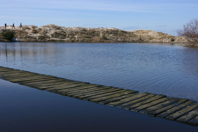 Scenic view of lake against blue sky