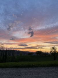 Scenic view of field against sky during sunset