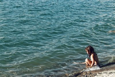 Woman sitting in sea