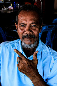 Portrait of man smiling man gesturing outdoors