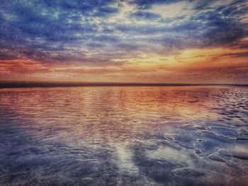 Scenic view of sea against cloudy sky