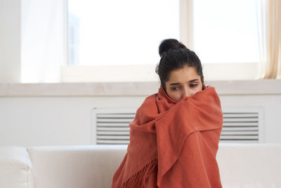 Portrait of young woman at home