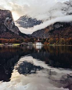 Scenic view of lake and snowcapped mountains against sky