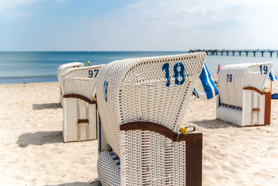 Beach chair on sand beach under blue sky and sunshine. german baltic sea beach scene.