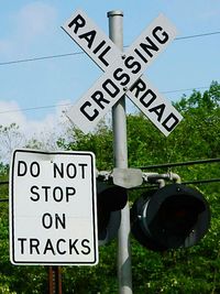 Low angle view of signboard on pole