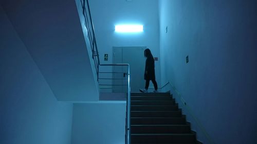 Silhouette of woman walking on staircase