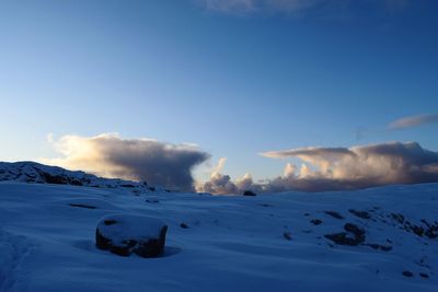 Scenic view of snow mountains against blue sky