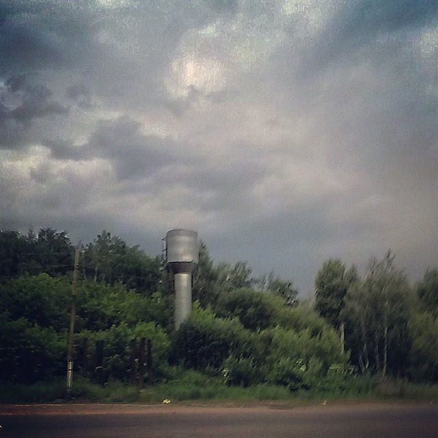 sky, cloud - sky, tree, cloudy, road, cloud, nature, growth, field, weather, landscape, built structure, green color, tranquility, transportation, outdoors, no people, beauty in nature, tranquil scene, day